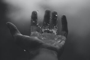 time lapse photography of water hitting left palm