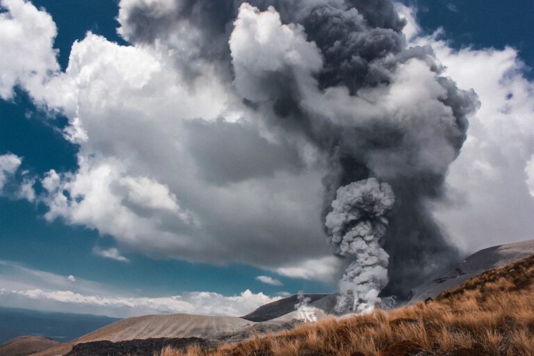 smoke rising towards the sky near brown grass field